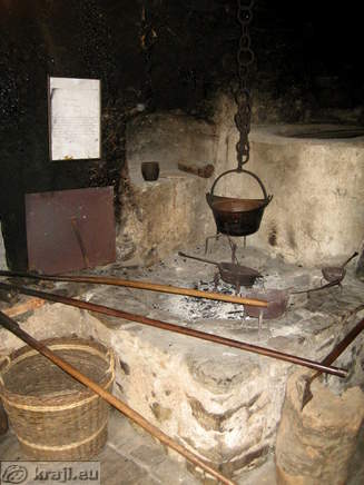 Black kitchen with three fireplaces in Oplen House in Studor