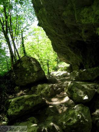 Footpath under overhanging wall