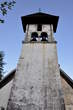 Kostel Castle - Church bell tower with three window slits in the walls and three church bells 