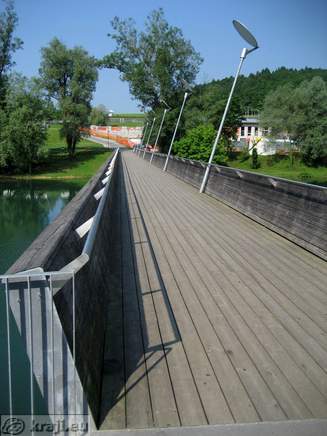 View of wooden bridge from other bank
