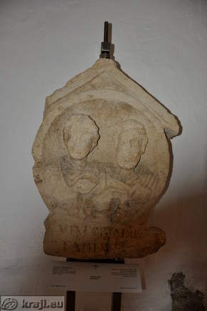 Tombstone in the shape of medallion, with busts of wife and husband