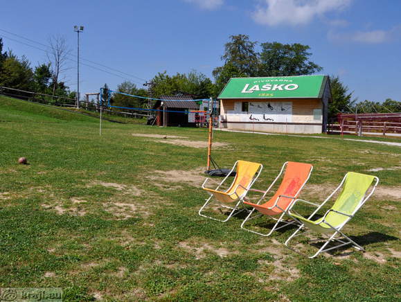 Chairs for sunbathing and the playground for beach volleyball