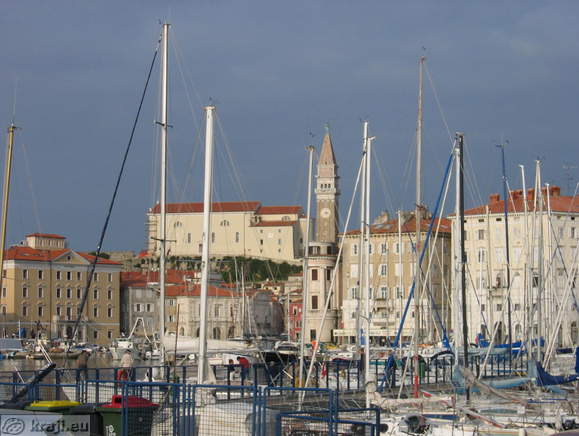 View of Piran through sailing boats in port